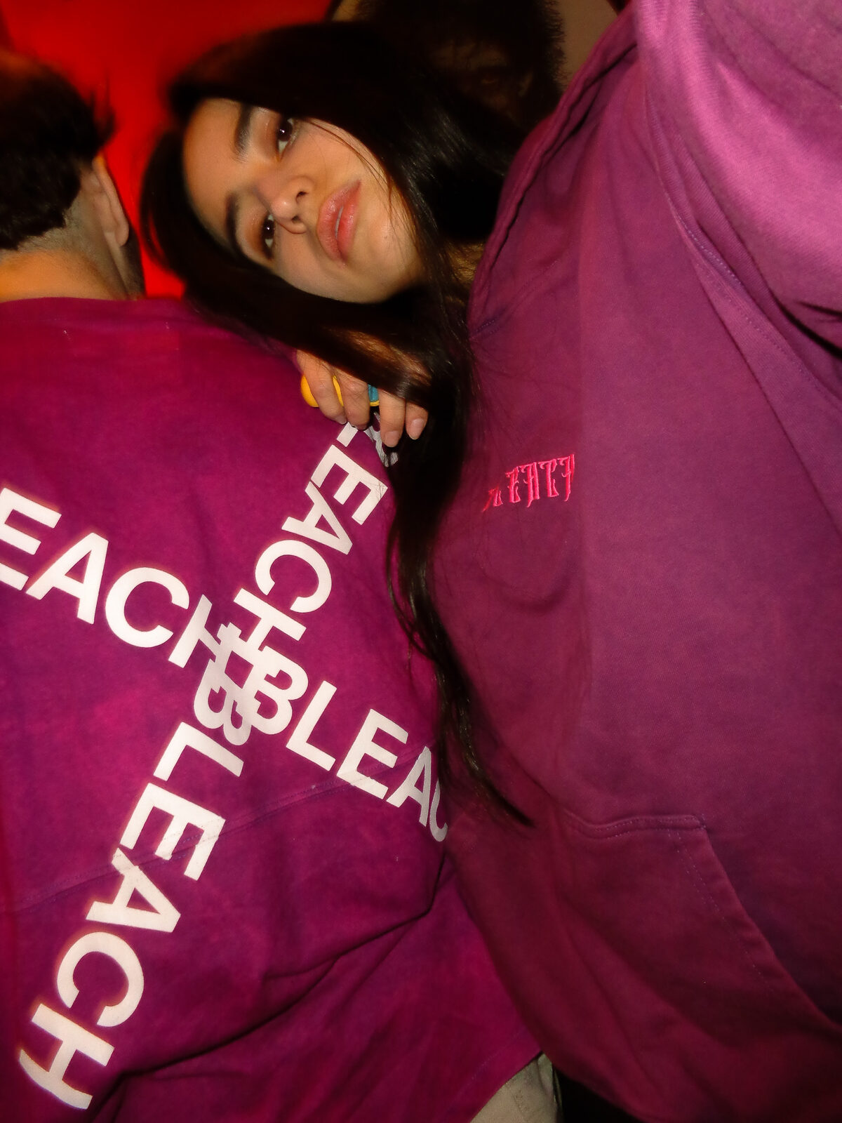 Two models in purple BLEACH script hoodies, candid lighting